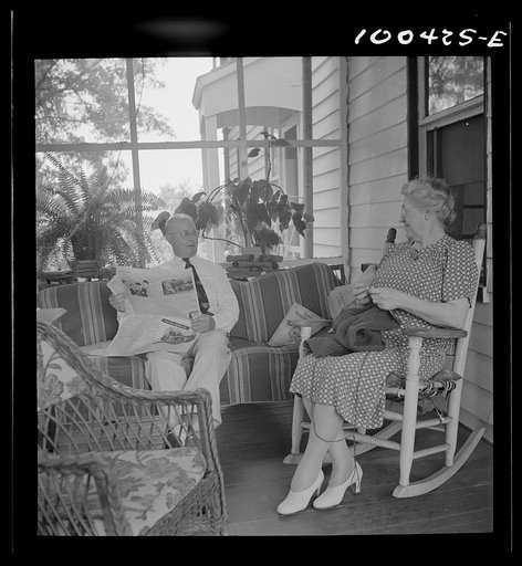 Mechanicsville, Maryland. Mr. and Mrs. Charles Herbert sitting on the porch of the home which he helped to build when he first came here thirty-six years ago to be a express agent. Mrs. Herbert is the town dressmaker