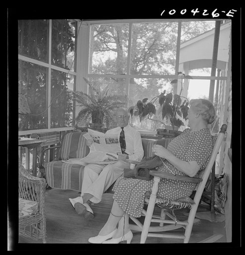 Untitled photo, possibly related to: Mechanicsville, Maryland. Mr. and Mrs. Charles Herbert sitting on the porch of the home which he helped to build when he first came here thirty-six years ago to be a express agent. Mrs. Herbert is the town dressmaker