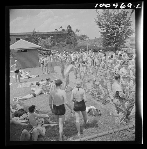 Untitled photo, possibly related to: Washington, D.C. Sunbathers on the grass next to the municipal swimming pool on Sunday