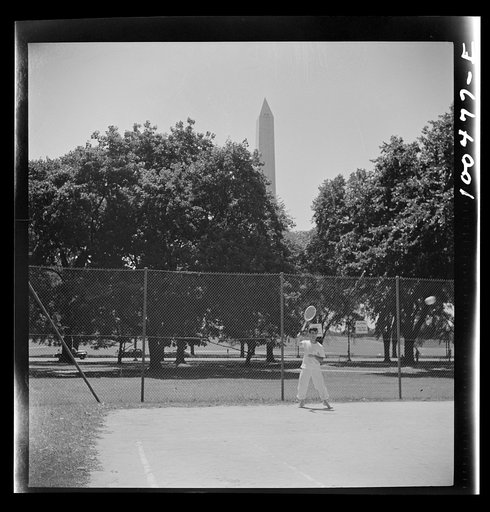 Washington, D.C. Playing tennis in the park in front of the U.S. Department of Commerce building on Sunday afternoon