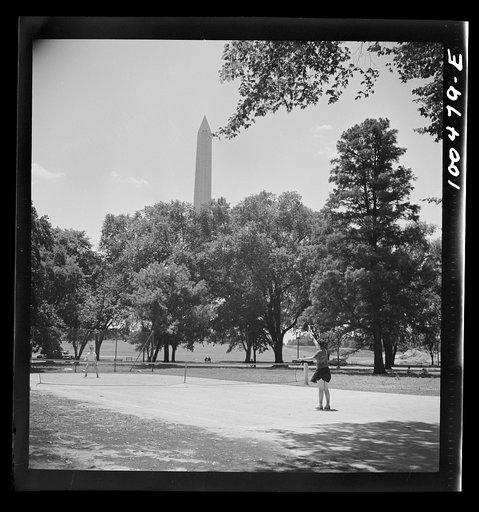 Untitled photo, possibly related to: Washington, D.C. Playing tennis in the park in front of the U.S. Department of Commerce building on Sunday afternoon