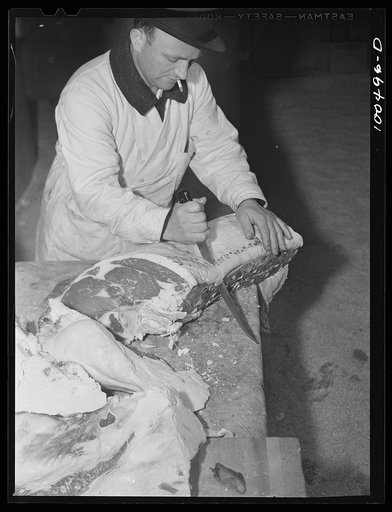 Washington, D.C. Cutting beef in the District grocery store warehouse
