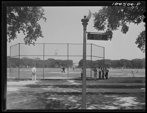 Washington, D.C. Amateur baseball game between two rival restaurants held on Sunday in the Ellipse. The White House is in the background