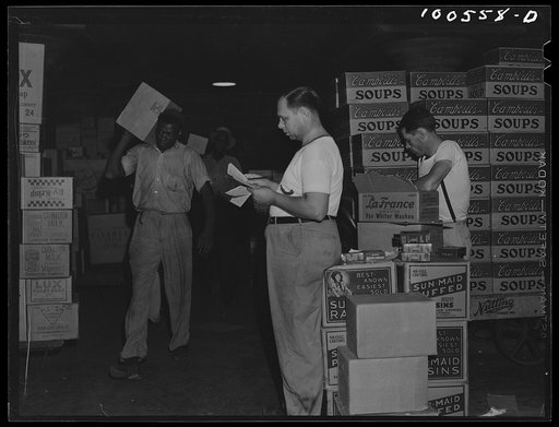 Washington, D.C. Grocery department of the District grocery store warehouse. Foreman calling out orders to be loaded onto small trucks