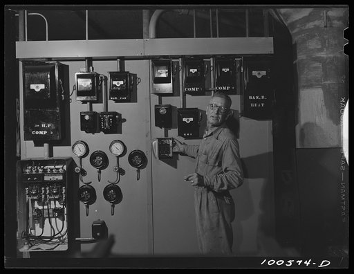 Untitled photo, possibly related to: Washington, D.C. Engineer Graham is a full-time employee at the District grocery store, on call at all hours of the day and night. He is responsible for air conditioning and keeping the storerooms and cold room at the right temperature