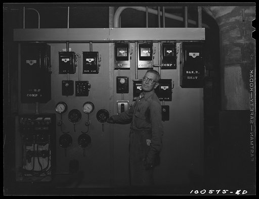 Untitled photo, possibly related to: Washington, D.C. Engineer Graham is a full-time employee at the District grocery store, on call at all hours of the day and night. He is responsible for air conditioning and keeping the storerooms and cold room at the right temperature