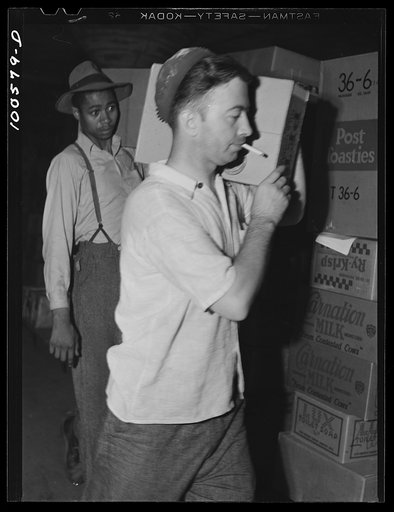 Untitled photo, possibly related to: Washington, D.C. Checking merchandise in the grocery department of the District grocery store warehouse