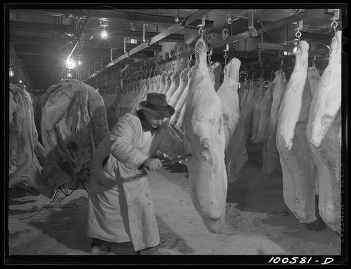 Untitled photo, possibly related to: Washington, D.C. Quartering beef in the District grocery store warehouse cold room