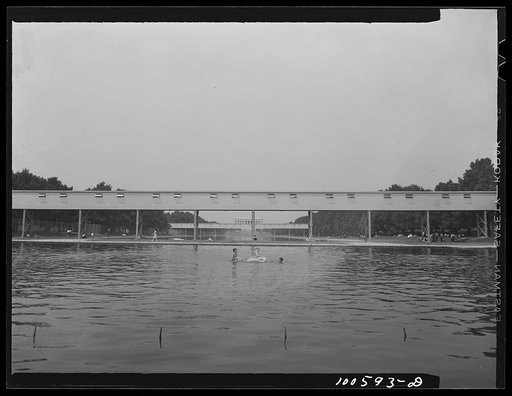 Washington, D.C. Lincoln Memorial lagoon, showing corridors between temporary war buildings, government workers eating lunch on the grass, and small boys swimming