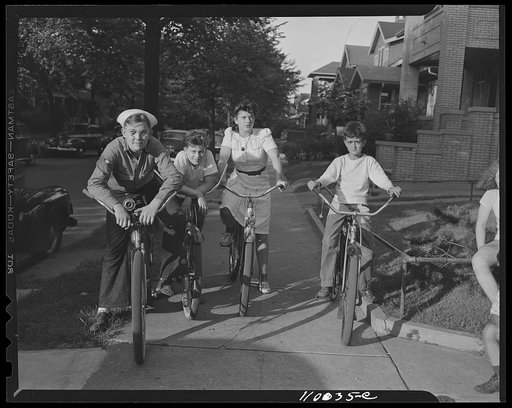 Detroit, Michigan. Boys and a girl on bicycles