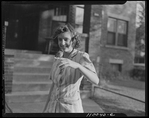 Detroit, Michigan. Girl with a captured sparrow