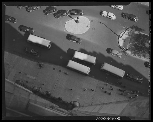 Detroit, Michigan. Tops of buses, automobiles and traffic island seen from the 14th story of the Fisher Building