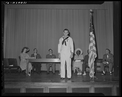 Detroit, Michigan. Sailor speaks to the audience at the salvage committee meeting
