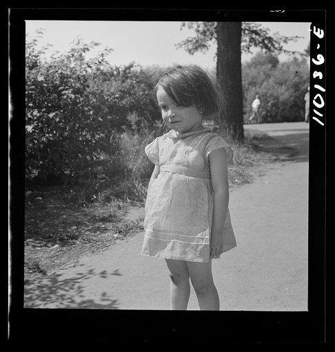 Detroit, Michigan. A little girl watching the flag presentation to doctors and nurses at the Harper Hospital