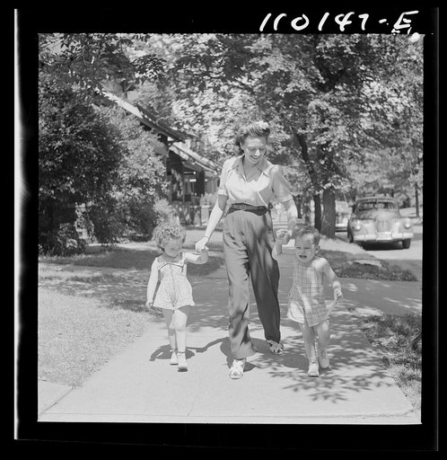 Detroit, Michigan. Young mother with her own and neighbor's child