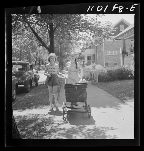 Detroit, Michigan. Little girl pushing a carriage