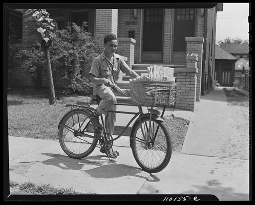Detroit, Michigan. Newsboy delivering papers