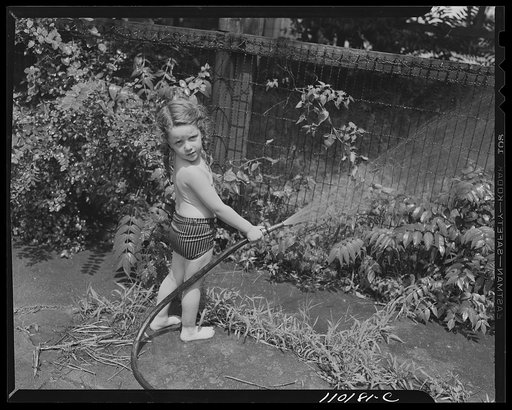 Detroit, Michigan. Little girl with hose