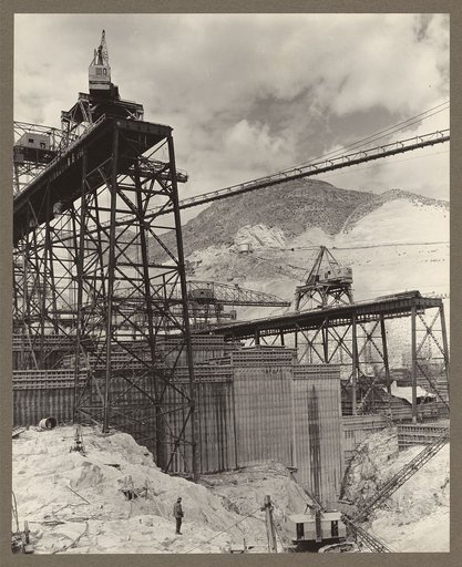 Grand Coulee Dam, Columbia Basin Reclamation Project. The east face of block 31 with a portion of the deep crevice shown in the foreground showing the high trestle, elev. 1028, high pour in center of picture at elev. 915; bottom of crevice at elev. 795; and deck of low trestle at elev. 950