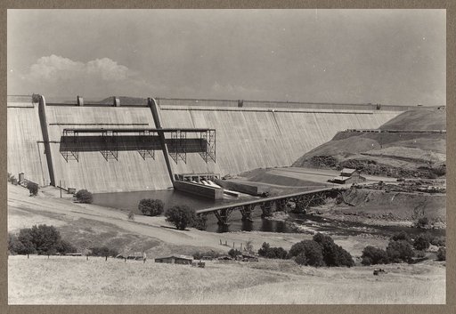 Friant Dam, Central Valley Reclamation Project, Calif. Panoramic view of downstream face of dam showing structure complete except for drum gates and control valves and miscellaneous installations