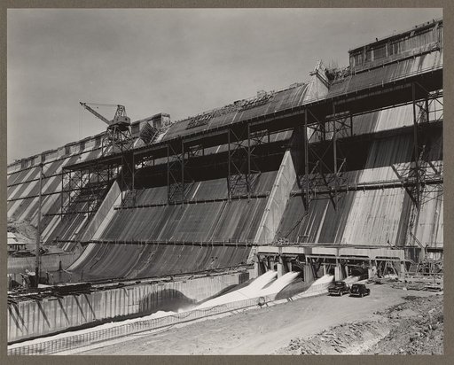 Friant Dam, Central Valley Reclamation Project, Calif. View from the left side of the downstream face of the spillway section, with river outlets discharging