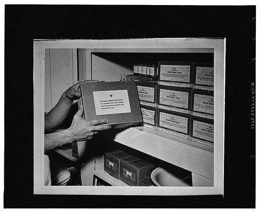 Hoffman, N.C. Boxes of dried blood plasma stored in a cabinet inside the operating tent which was set up during the Carolina maneuvers