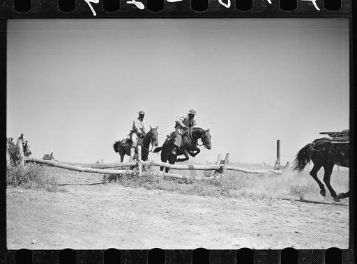 Fort Riley, Kansas. Soldiers of a cavalry machine gun platoon going over an obstacle during a field problem