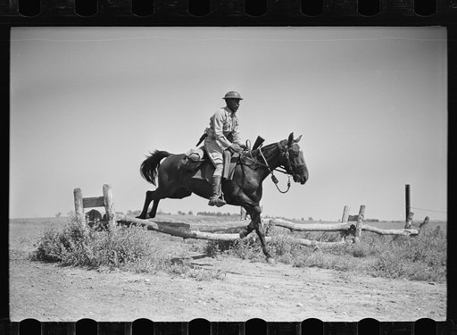 Fort Riley, Kansas. Soldiers of a cavalry machine gun platoon going over an obstacle during a field problem
