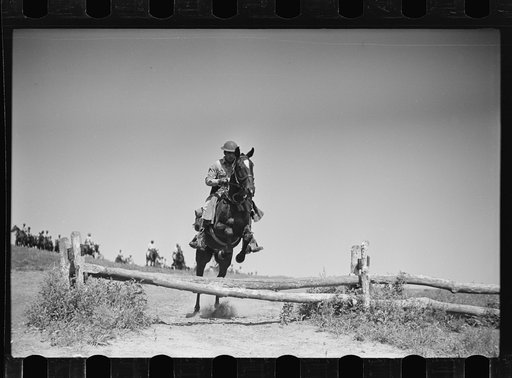Fort Riley, Kansas. Soldiers of a cavalry machine gun platoon going over an obstacle during a field problem
