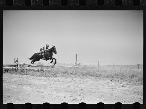 Fort Riley, Kansas. Soldiers of a cavalry machine gun platoon going over an obstacle during a field problem