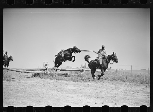 Fort Riley, Kansas. Soldiers of a cavalry machine gun platoon going over an obstacle during a field problem