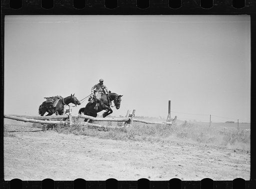 Fort Riley, Kansas. Soldiers of a cavalry machine gun platoon going over an obstacle during a field problem