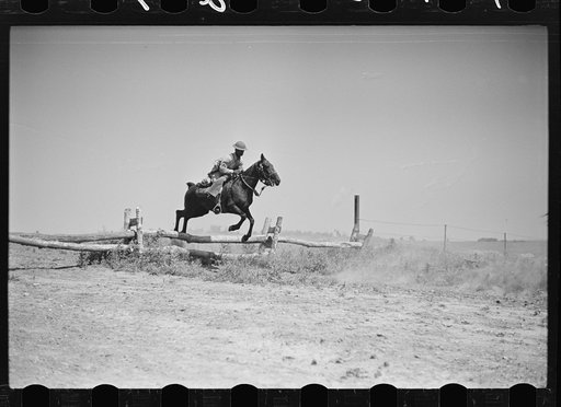 Fort Riley, Kansas. Soldiers of a cavalry machine gun platoon going over an obstacle during a field problem