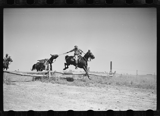 Fort Riley, Kansas. Soldiers of a cavalry machine gun platoon going over an obstacle during a field problem