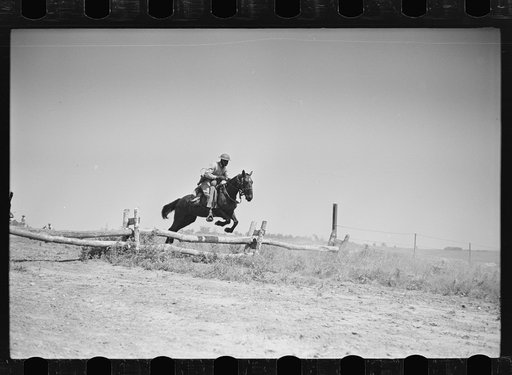 Fort Riley, Kansas. Soldiers of a cavalry machine gun platoon going over an obstacle during a field problem