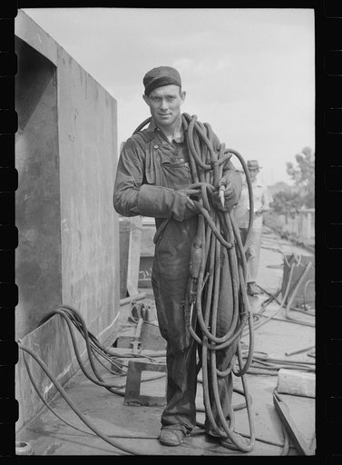 Decatur, Alabama. Ingalls Shipbuilding Company. Welder going to his place of work on a barge