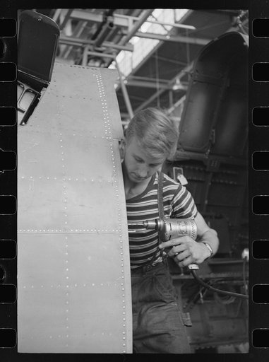 Nashville, Tennessee. Vultee Aircraft Company. Using an electric drill on a fuselage in a sub-assembly section