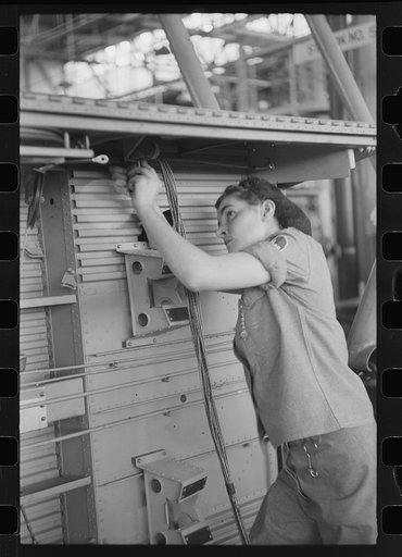 Nashville, Tennessee. Vultee Aircraft Company. Installing electric wiring in a fuselage