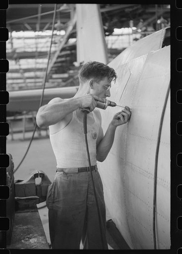 Nashville, Tennessee. Vultee Aircraft Company. Drilling holes for rivets in a fuselage in a sub-assembly line