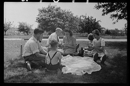 Washington, D.C. Group of gardeners from the Fairlawn Avenue victory gardens eating a picnic lunch outside the Anacostia River after a morning spent working on their plots
