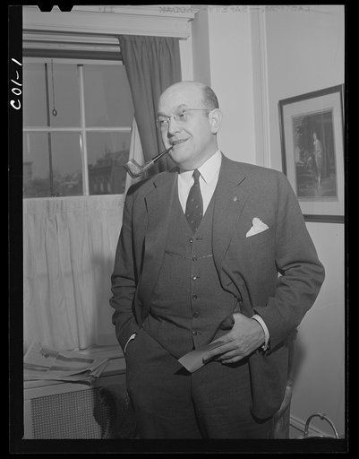 Assistant Secretary of War Louis A. Johnson(?) photographed in his home. Washington, D.C.
