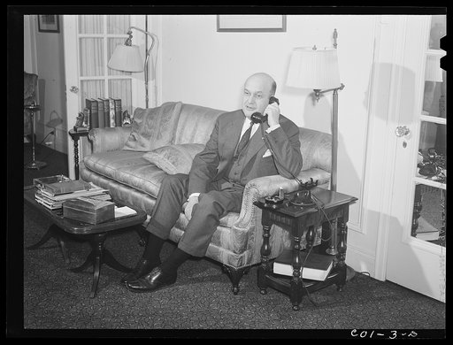 Assistant Secretary of War Louis A. Johnson(?) photographed in his home. Washington, D.C.