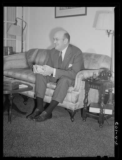 Assistant Secretary of War Louis A. Johnson(?) photographed in his home. Washington, D.C.