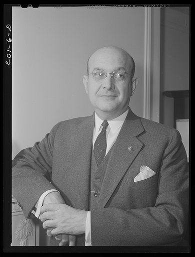 Assistant Secretary of War Louis A. Johnson(?) photographed in his home. Washington, D.C.