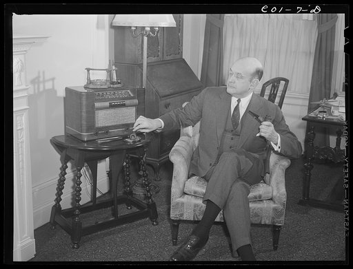 Assistant Secretary of War Louis A. Johnson(?) photographed in his home. Washington, D.C.