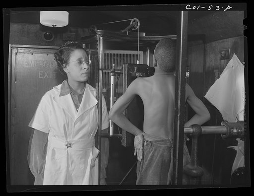 Miss Marion Rhodes, a graduate nurse from Meharry Medical College, Nashville, Tennessee, assisting the x-raying of one of the children on the project. X-ray clinic at the hospital of the Ida B. Wells Housing Project, Chicago, Illinois