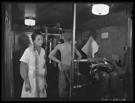 Untitled photo, possibly related to: Miss Marion Rhodes, a graduate nurse from Meharry Medical College, Nashville, Tennessee, assisting the x-raying of one of the children on the project. X-ray clinic at the hospital of the Ida B. Wells Housing Project, Chicago, Illinois