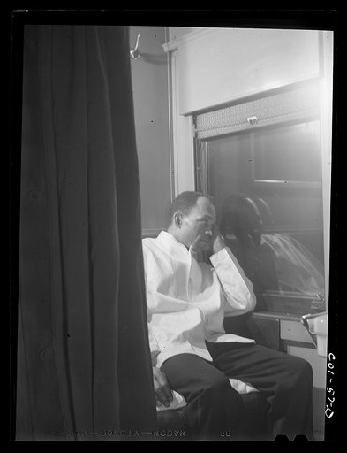 Untitled photo, possibly related to: Alfred MacMillan, Pullman porter resting in the men's washroom aboard the "Capitol Limited" bound for Chicago, Illinois