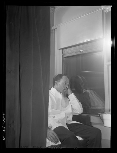 Untitled photo, possibly related to: Alfred MacMillan, Pullman porter resting in the men's washroom aboard the "Capitol Limited" bound for Chicago, Illinois
