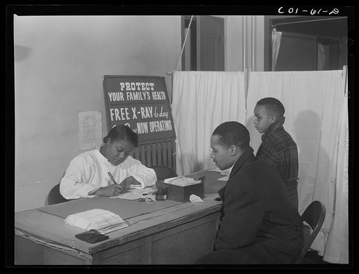 Miss Olive Smith interviewing applicants for x-rays at the x-ray clinic at the hospital of the Ida B. Wells Housing Project, Chicago, Illinois